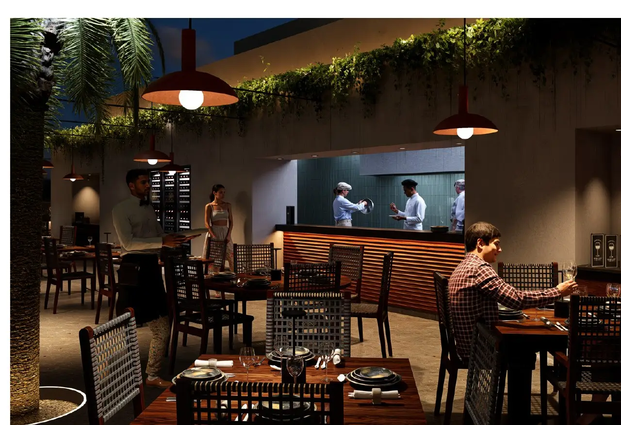 Open kitchen with chefs cooking over fire at N'TRE Cocina al Fuego in Cabo San Lucas